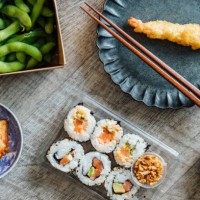 enjoying japanese takeaway meal at home - junk food stock pictures, royalty-free photos & images