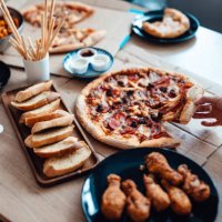 enjoying takeaway meals at home - junk food stock pictures, royalty-free photos & images