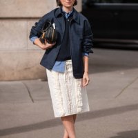 Erika Boldrin wears blue checked shirt, blue polo neck top, blue Miu Miu jacket, white decorated midi skirt, black heels, black Miu Miu bag, outside...