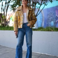 Eva Chen wears white tank top, light brown cream gold pattern detail oversized jacket, washed denim jean pants, light brown ballerina flats leather...