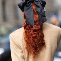 Evelyn Karantzoglou is seen red hair, a beige coat and a black bow wearing outside the Max Mara show during the Milan Fashion Week - Womenswear...