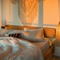 evening romantic mood in bedroom. stylish room with handmade design elements in boho style. beautiful light in cozy home. - home decoration stock pictures, royalty-free photos & images