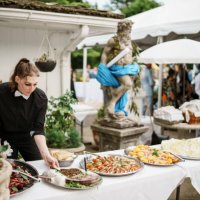 event manager sets up dinner table at wedding reception - garden decoration stock pictures, royalty-free photos & images