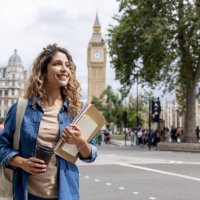 exchange student walking outdoors in london and drinking coffee - travel stock pictures, royalty-free photos & images