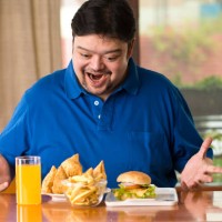 excited fat man with plate of samosa - junk food stock pictures, royalty-free photos & images