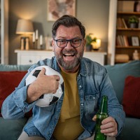 excited mature man watching football game on tv at home - home decoration stock pictures, royalty-free photos & images