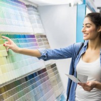 excited new home owner picks out paint color - home decoration stock pictures, royalty-free photos & images