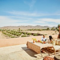 extreme wide shot couple relaxing on rooftop terrace of luxury resort - food stock pictures, royalty-free photos & images