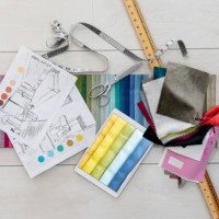 fabric swatches and tailoring tools on the table of a textile shop - fashion stock pictures, royalty-free photos & images