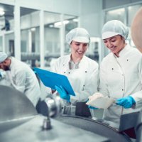factory workers filling machine with cottage cheese for stuffed peppers in jars - food stock pictures, royalty-free photos & images