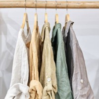 fair trade linen organic clothes of neutral tones on hanger - fashion stock pictures, royalty-free photos & images