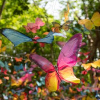 fake fabric butterflies art hang in garden background - garden decoration stockfoto's en -beelden