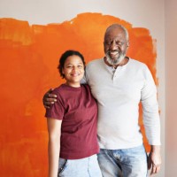 family against orange wall during home renovation - home decoration stock pictures, royalty-free photos & images