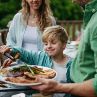 family barbecue in backyard. multigenerational family come together, enjoying grilled food and spending quality time outdoors together. - food stock pictures, royalty-free photos & images