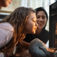 family checking the traditional turkey for christmas dinner - food stock pictures, royalty-free photos & images