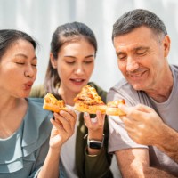 family dining at home on pizza during lunch - junk food stock pictures, royalty-free photos & images