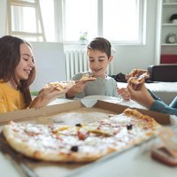 family eating pizza at home - junk food stock pictures, royalty-free photos & images