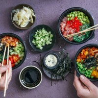 family eating takeaway poke bowls - junk food stock pictures, royalty-free photos & images