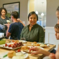 family eating together at holiday table - food stock pictures, royalty-free photos & images