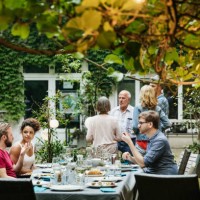 family eating together in courtyard - garden decoration stock pictures, royalty-free photos & images