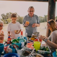 family enjoying a bbq in the park - junk food stock pictures, royalty-free photos & images
