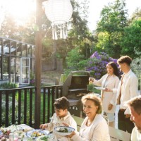 family enjoying summer dinner party at back yard - garden decoration photos et images de collection