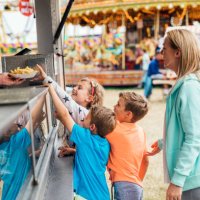family getting food at the fairground - junk food stock pictures, royalty-free photos & images