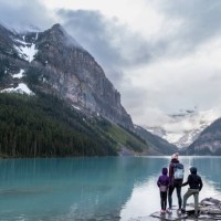 family hiking around a pristine glacial lake in banff national park - travel stock pictures, royalty-free photos & images