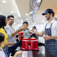 family making a contactless payment while buying snacks at the cinema - junk food stock pictures, royalty-free photos & images