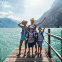 family standing on pier and enjoying view of lake garda - travel stock pictures, royalty-free photos & images