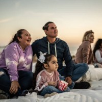 family watching a movie at outdoors cinema - concert stock pictures, royalty-free photos & images