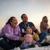 family watching a movie at the outdoors cinema - concert stock pictures, royalty-free photos & images
