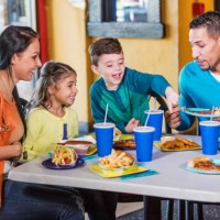 family with two children eating fast food - junk food stock pictures, royalty-free photos & images