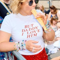 Fan enjoys an ice lolly as Swifties arrive to attend the concert of US singer and songwriter Taylor Swift as part of her 'Eras Tour' at Wembley...