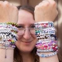 Fan of US singer Taylor Swift - a swiftie - presents her beaded bracelets near the Swiftie Tree in Cornelius Strasse street in Vienna, Austria, on...