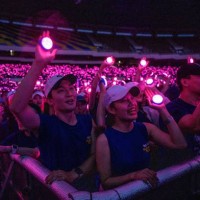 Fans hold up LED lights as South Korean singer PSY performs during his 