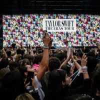 Fans wait for the arrival on stage of US singer and songwriter Taylor Swift at the Groupama Stadium as part of The Eras Tour, in Decines-Charpieu,...