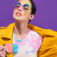 fashion artist painter girl with brush painting herself t-shirt on purple - fashion stock pictures, royalty-free photos & images