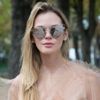 Fashion blogger Anastasiia Masiutkina wears a Nadya Pzyak dress and Saint Laurent sunglasses day 5 of Paris Womens Fashion Week Spring/Summer 2018,...