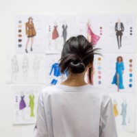 fashion design student looking at sketch illustrations at the atelier - fashion stock pictures, royalty-free photos & images