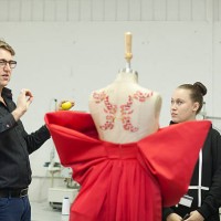 fashion design teacher assessing students work - fashion stock pictures, royalty-free photos & images