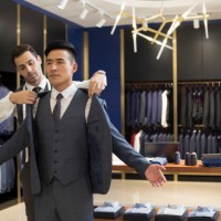 fashion designer examining suit on customer - fashion stock pictures, royalty-free photos & images