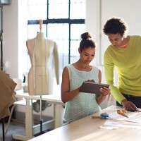 fashion designers working together in their studio - fashion stock pictures, royalty-free photos & images