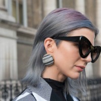 Fashion influencer Samantha Angelo of The Eye Travels wears a Marques Almeida coat, Sunday Somewhere sunglasses and Balenciaga earrings day 2 of...