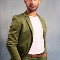 fashion model portrait, sexy young man with hands in pocket and studio on grey background. casual cool latino person with trendy suit jacket with stylish white shirt and modern professional style - fashion stock pictures, roy