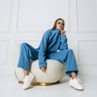 fashion model woman posing sitting on armchair in studio room. pretty lady with glasses indoors - fashion stock-fotos und bilder