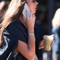 Fashion Week guest is seen wearing sunglasses, several rings, a dark blue shirt, and a silver watch from Cartier before the Ulla Johnson Show during...