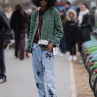Fashion Week Guest seen wearing a green checkered Chanel blazer, denim blue jeans pants with black details, white shoes, black shirt and black...