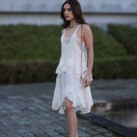 Fashion Week Guest seen wearing a white dress, transparent top with dots, black sandals heels and beige bag outside Stella McCartney show, during the...