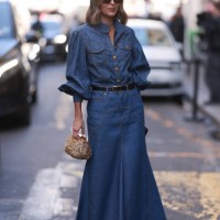 Fashion Week guest was seen wearing dark shades, a golden bag as well as a denim set from Zimmermann including a long denim jeans skirt with black...